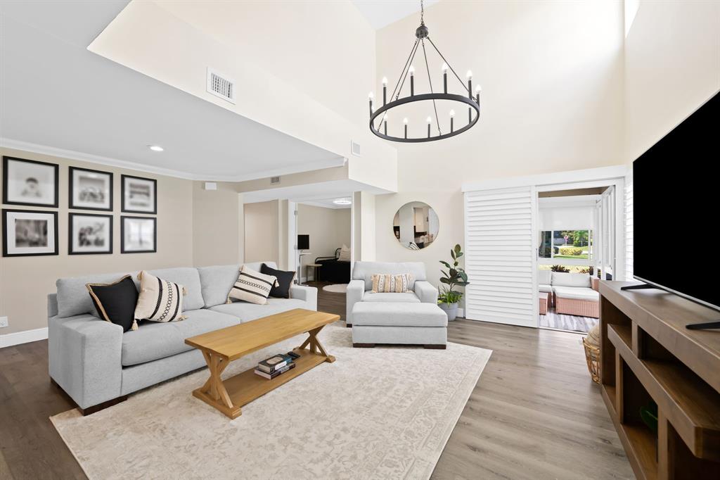 5298 Buckhead Circle, Unit 1040 Boca Raton, FL 33431 - Photo 4 of 25 a living room with furniture and a flat screen tv