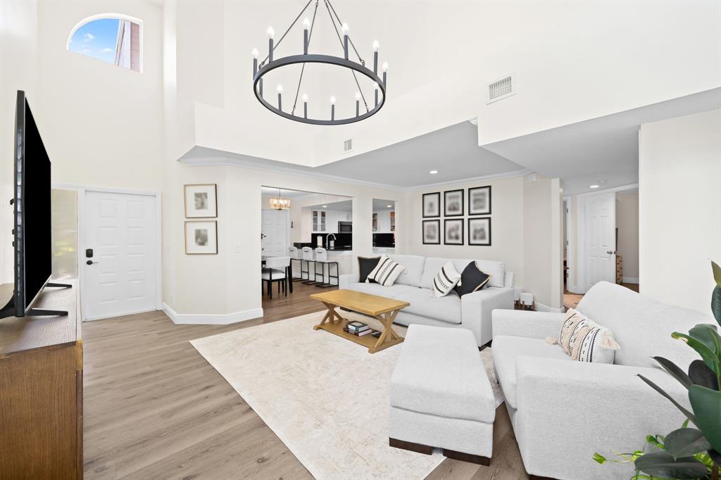 5298 Buckhead Circle, Unit 1040 Boca Raton, FL 33431 - Photo 5 of 25 a living room with furniture a mirror and a flat screen tv