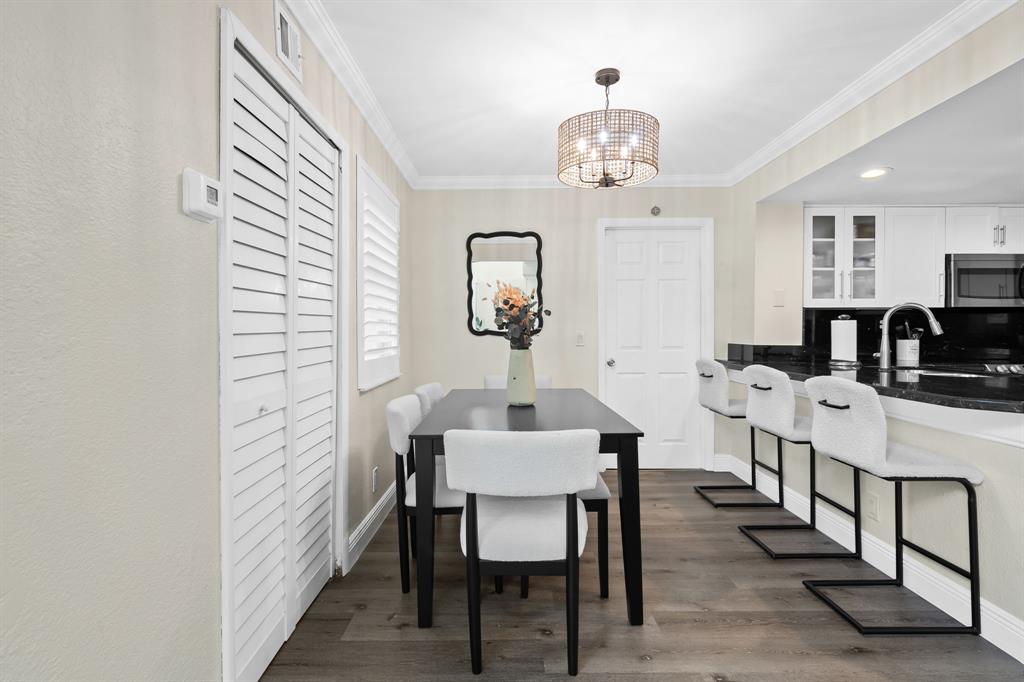 5298 Buckhead Circle, Unit 1040 Boca Raton, FL 33431 - Photo 7 of 25 a view of a dining room with furniture and wooden floor