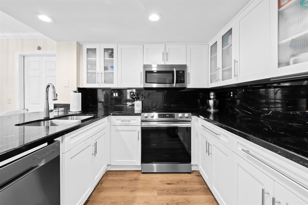 5298 Buckhead Circle, Unit 1040 Boca Raton, FL 33431 - Photo 9 of 25 a kitchen with stainless steel appliances granite countertop a sink and a stove