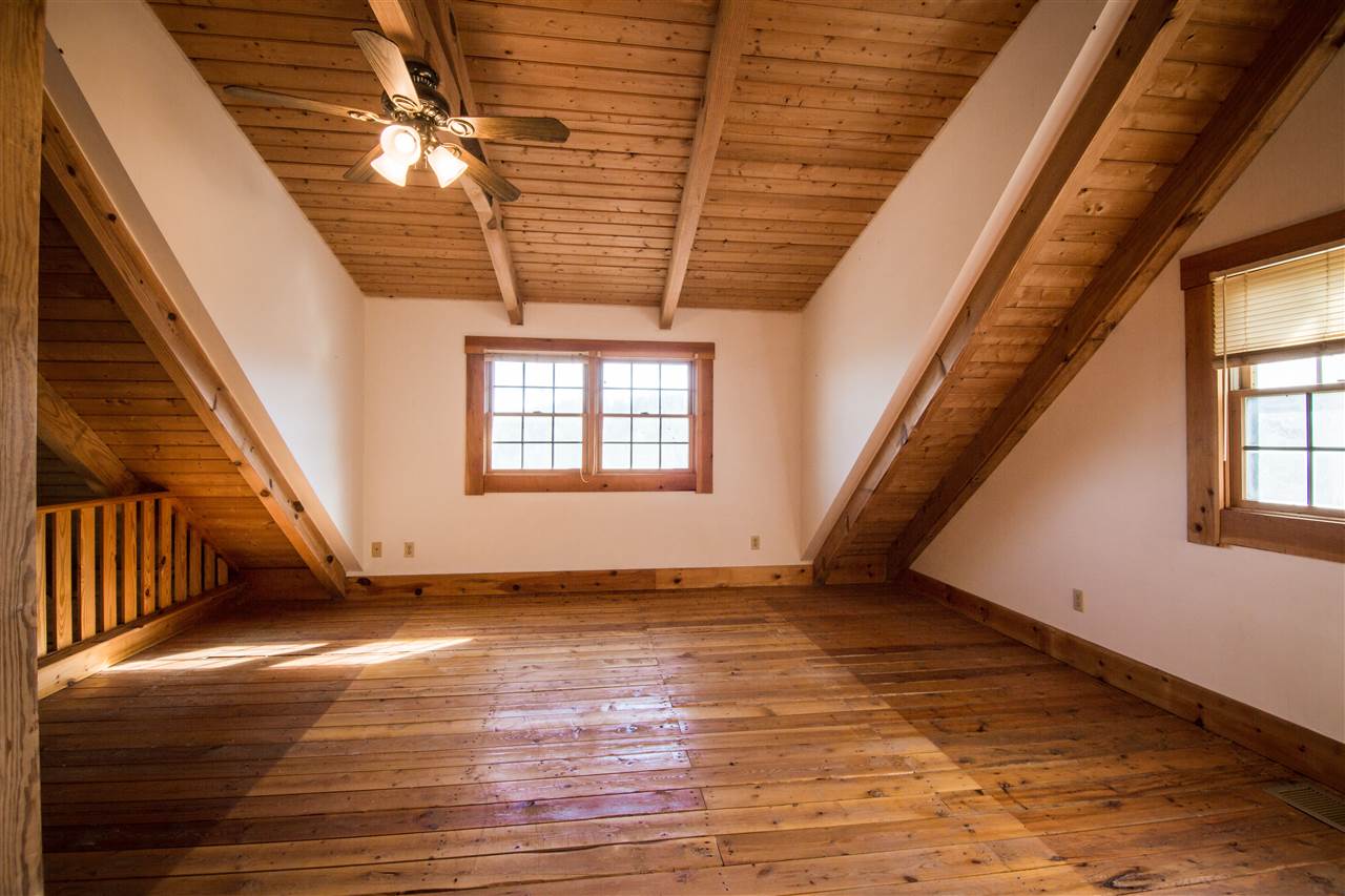 919 Roman Road Mount Sidney, VA 24467 - Photo 18 of 32 a view of an empty room with wooden floor and fan