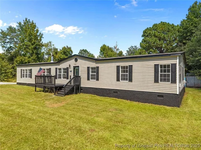 a view of a house with pool and sitting area