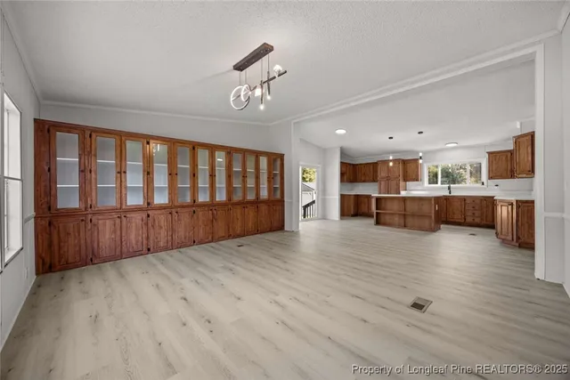 a view of kitchen with wooden floor and electronic appliances