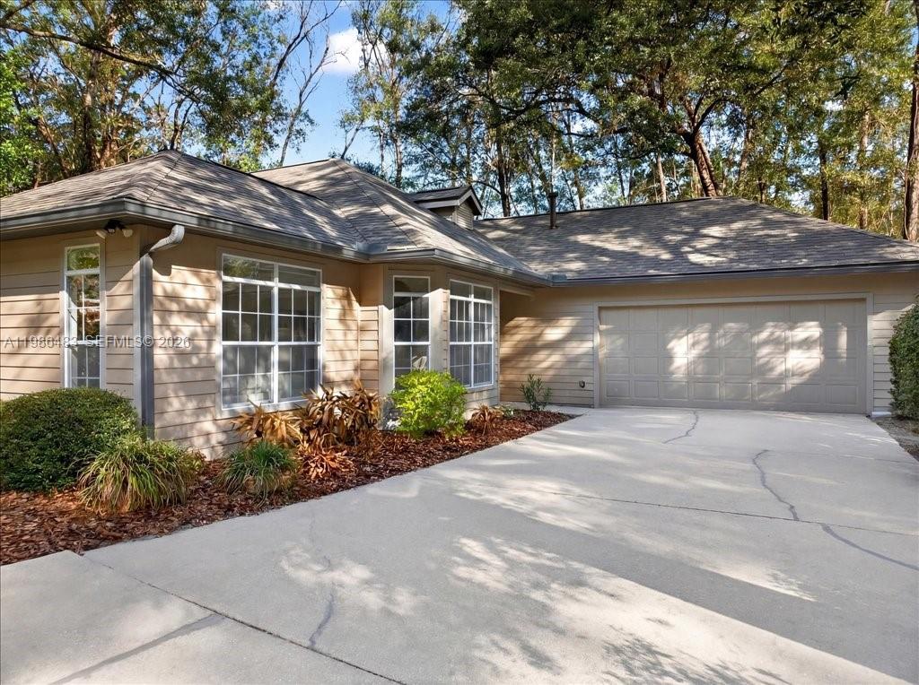 4412 Southwest 101 Drive Gainesville, FL 32608 - Photo 25 of 52 a view of a house with a yard and plants