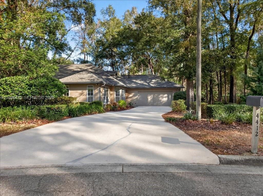 4412 Southwest 101 Drive Gainesville, FL 32608 - Photo 3 of 52 a view of a road with plants and trees