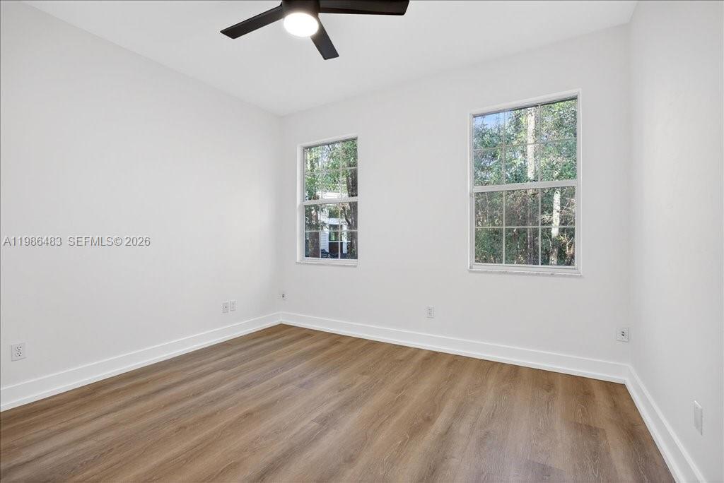 4412 Southwest 101 Drive Gainesville, FL 32608 - Photo 40 of 52 an empty room with a window and a ceiling fan