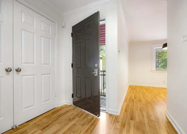 a view of hallway with wooden floor