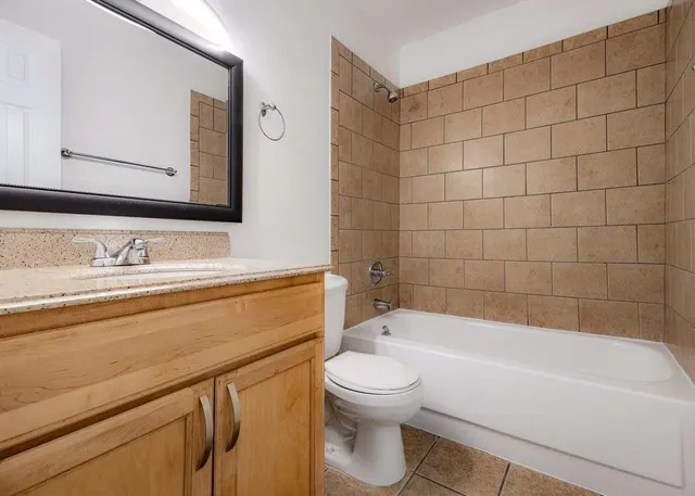a bathroom with a sink a toilet and bathtub