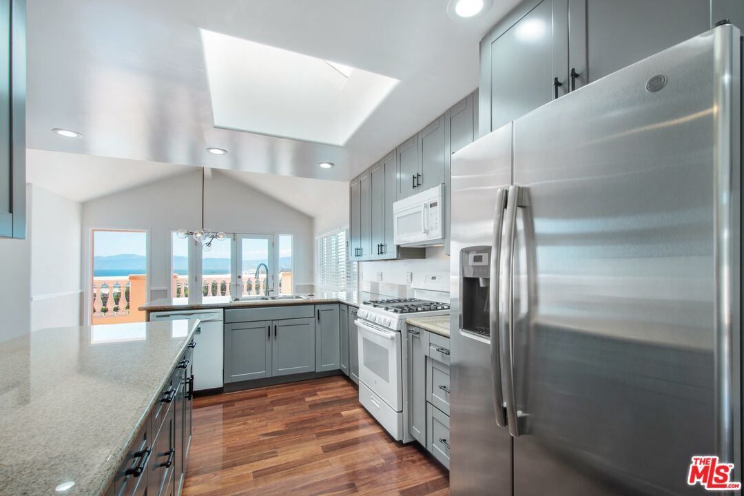 217 Fowling Street Playa del Rey, CA 90293 - Photo 20 of 51 a kitchen with stainless steel appliances kitchen island granite countertop a refrigerator and a sink