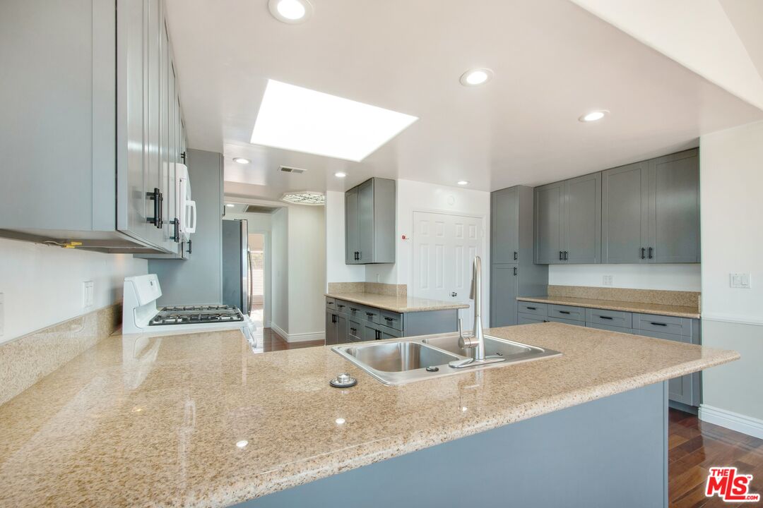 217 Fowling Street Playa del Rey, CA 90293 - Photo 21 of 51 a kitchen with stainless steel appliances granite countertop a sink a stove and a refrigerator