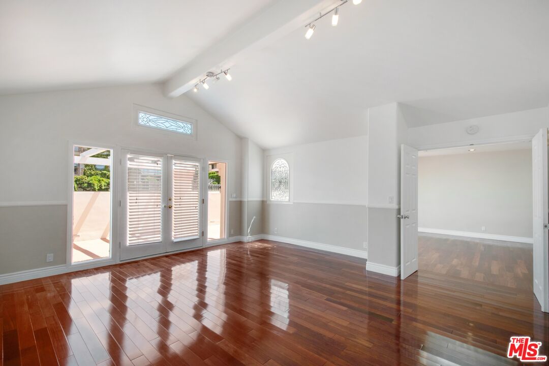 217 Fowling Street Playa del Rey, CA 90293 - Photo 24 of 51 a view of an empty room with window and wooden floor