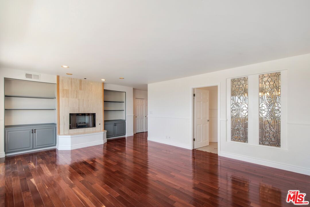 217 Fowling Street Playa del Rey, CA 90293 - Photo 29 of 51 an empty room with wooden floor fireplace and windows