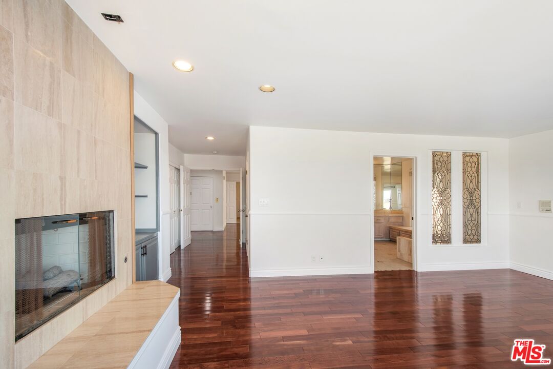 217 Fowling Street Playa del Rey, CA 90293 - Photo 30 of 51 a view of a hallway with wooden floor and a fireplace