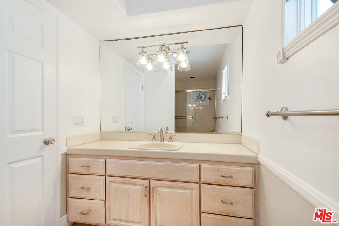 217 Fowling Street Playa del Rey, CA 90293 - Photo 37 of 51 a bathroom with a shower sink vanity and mirror