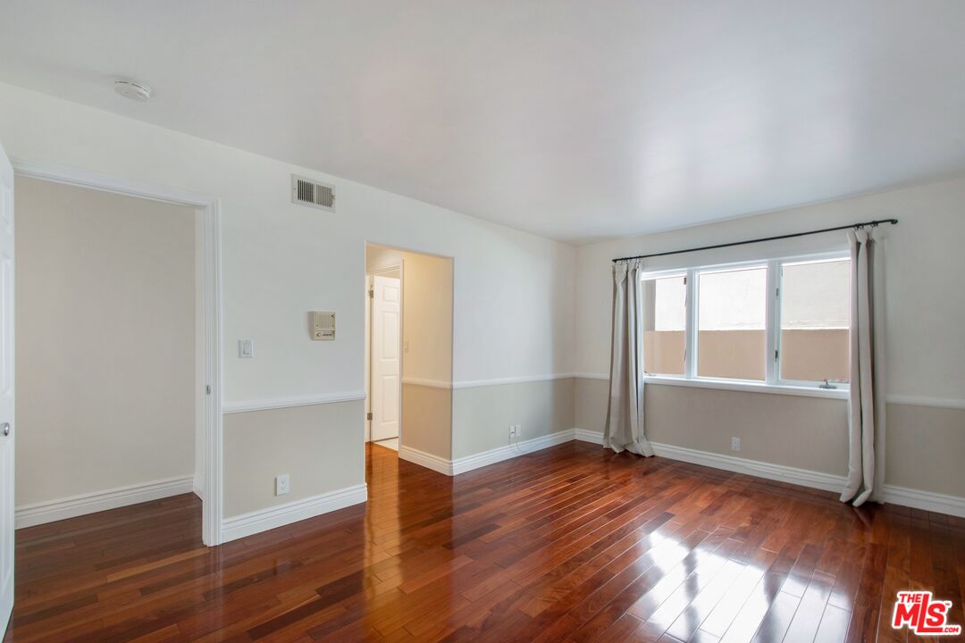 217 Fowling Street Playa del Rey, CA 90293 - Photo 39 of 51 an empty room with wooden floor and windows