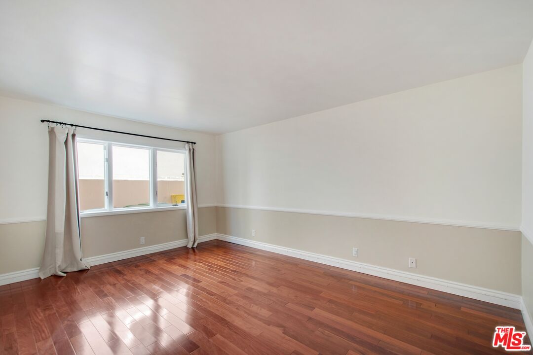 217 Fowling Street Playa del Rey, CA 90293 - Photo 40 of 51 an empty room with wooden floor and windows