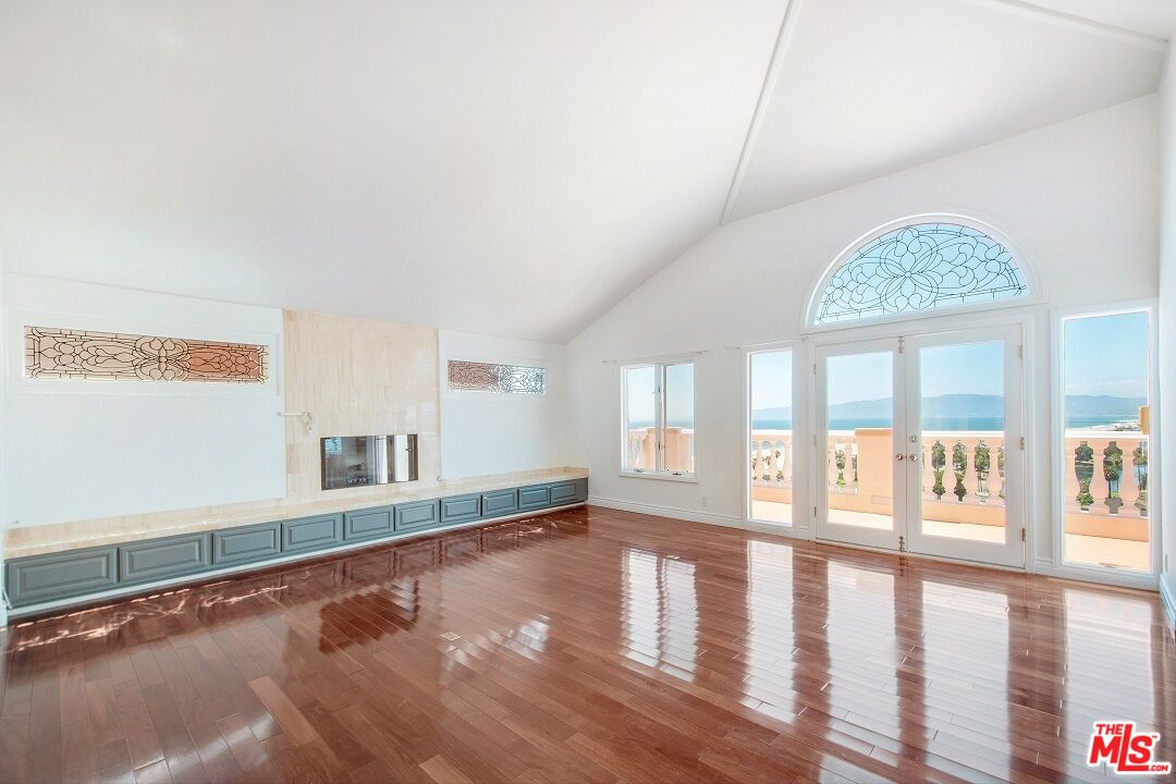 217 Fowling Street Playa del Rey, CA 90293 - Photo 9 of 51 a view of an empty room with wooden floor and a window