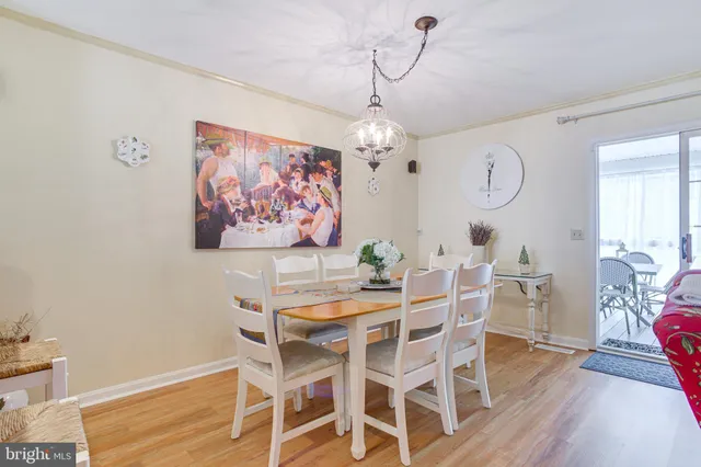 a view of a dining room with furniture wooden floor and a chandelier