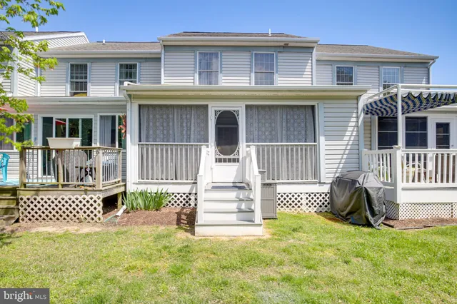 a front view of a brick house with a yard