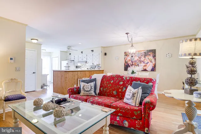a living room with furniture and a chandelier