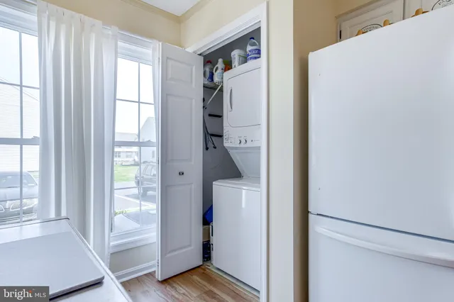 a kitchen with a refrigerator sink and cabinets
