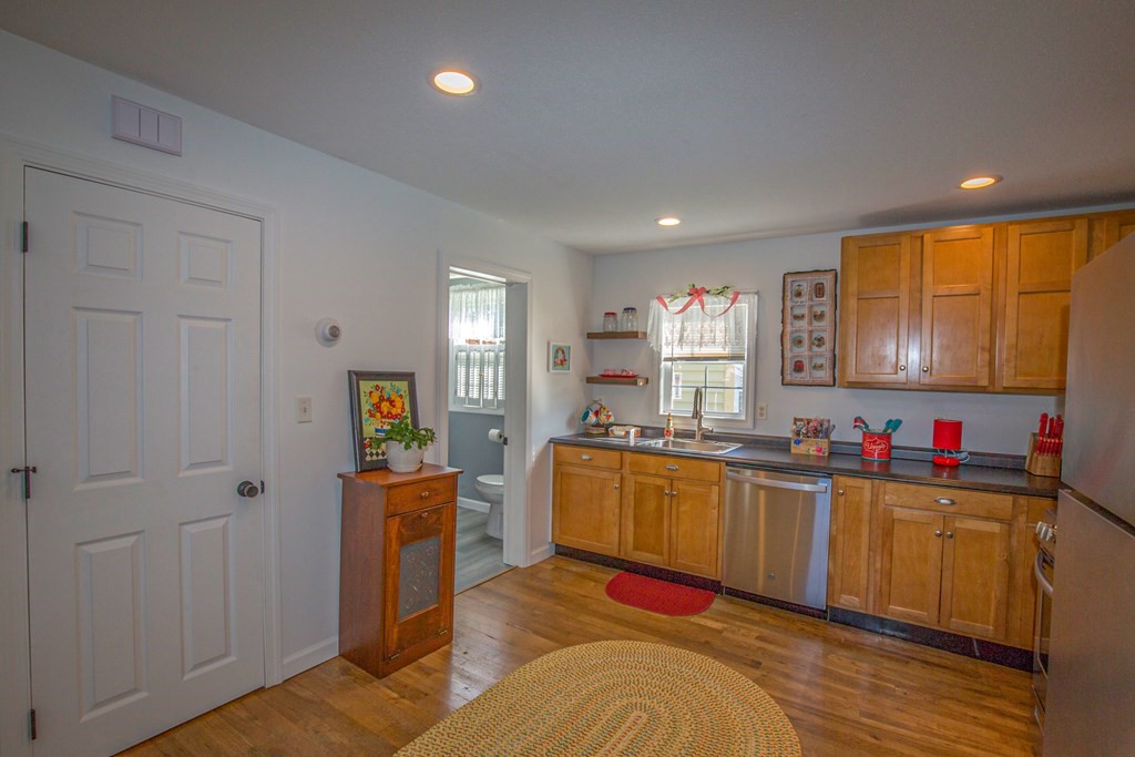 130 Cottage Road Enfield, CT 06082 - Photo 5 of 33 a kitchen with stainless steel appliances granite countertop a sink stove and wooden cabinets