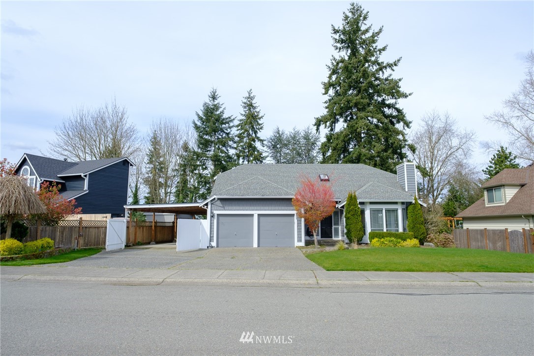 2211 236th Street Southeast Bothell, WA 98021 - Photo 2 of 26 a front view of house with yard and car parked