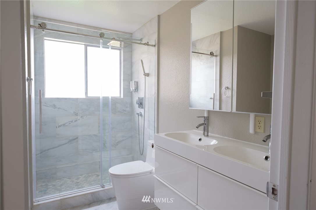2211 236th Street Southeast Bothell, WA 98021 - Photo 11 of 26 a bathroom with a shower sink vanity and toilet