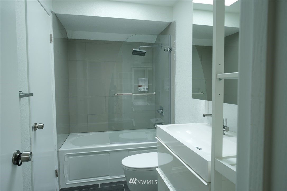 2211 236th Street Southeast Bothell, WA 98021 - Photo 14 of 26 a bathroom with a bathtub shower sink vanity and toilet