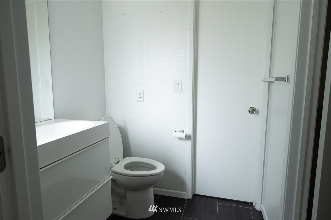 2211 236th Street Southeast Bothell, WA 98021 - Photo 18 of 26 a bathroom with a toilet and a sink