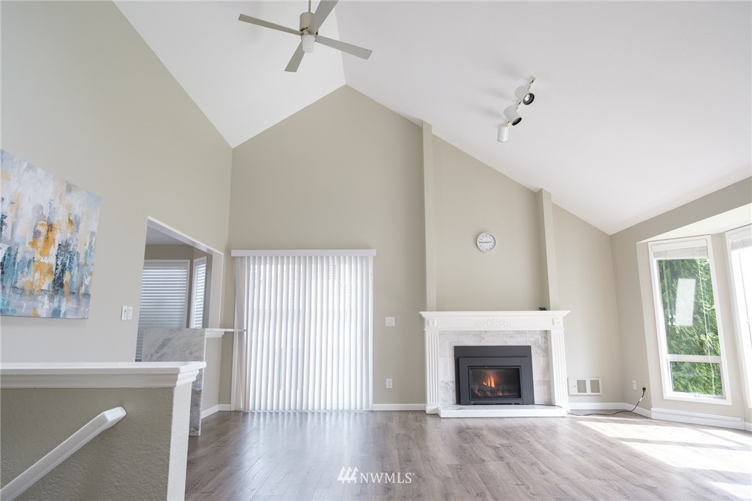 2211 236th Street Southeast Bothell, WA 98021 - Photo 6 of 26 a view of a livingroom with wooden floor and a fireplace