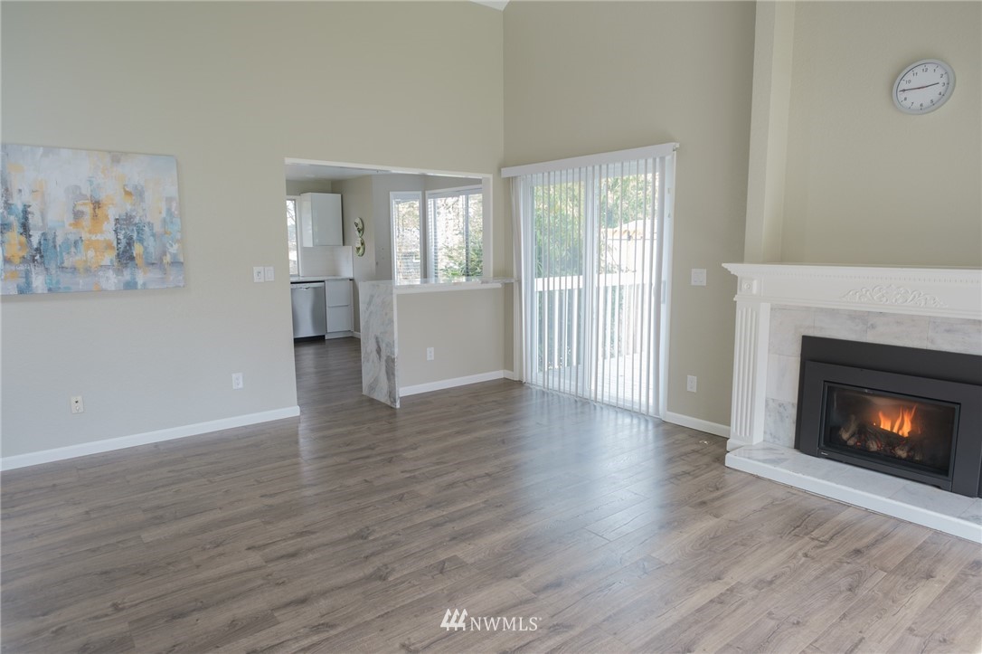 2211 236th Street Southeast Bothell, WA 98021 - Photo 8 of 26 a view of an empty room with wooden floor and a window
