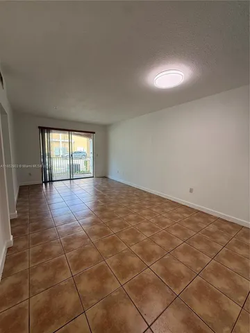 a view of an empty room and a window