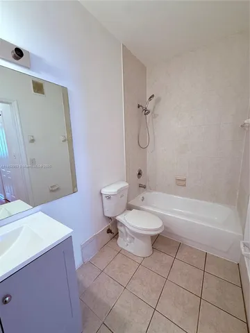 a bathroom with a toilet a sink and bathtub