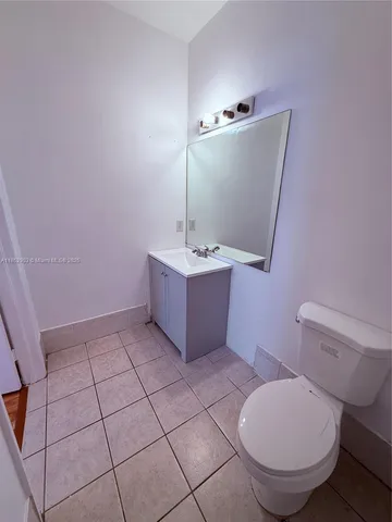 a bathroom with a sink mirror vanity and toilet