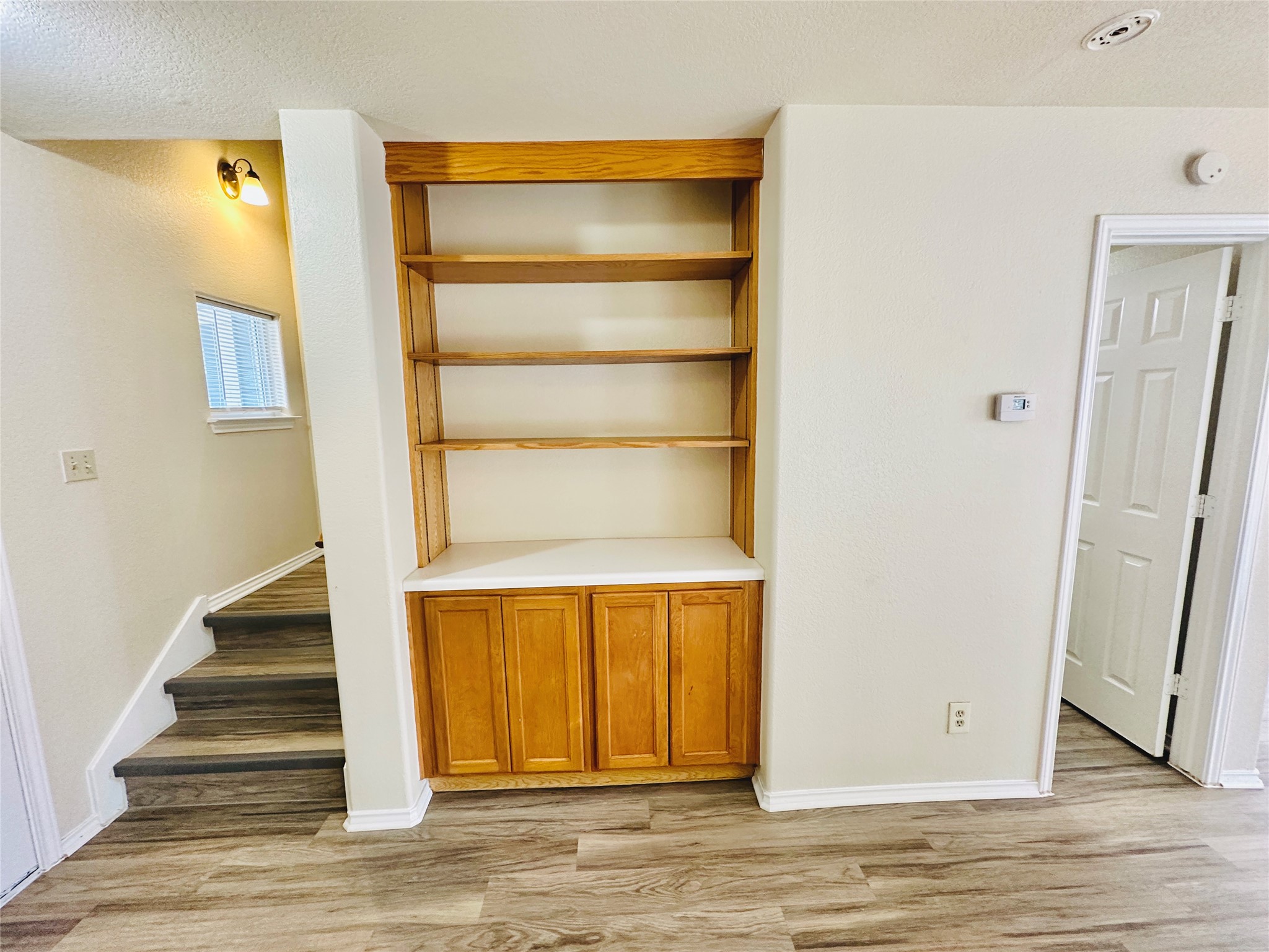 8814 Schick Road, Unit C Austin, TX 78729 - Photo 15 of 35 Built-in shelving and cabinets provide ample storage, complementing the durable wood-look flooring and easy stair access.