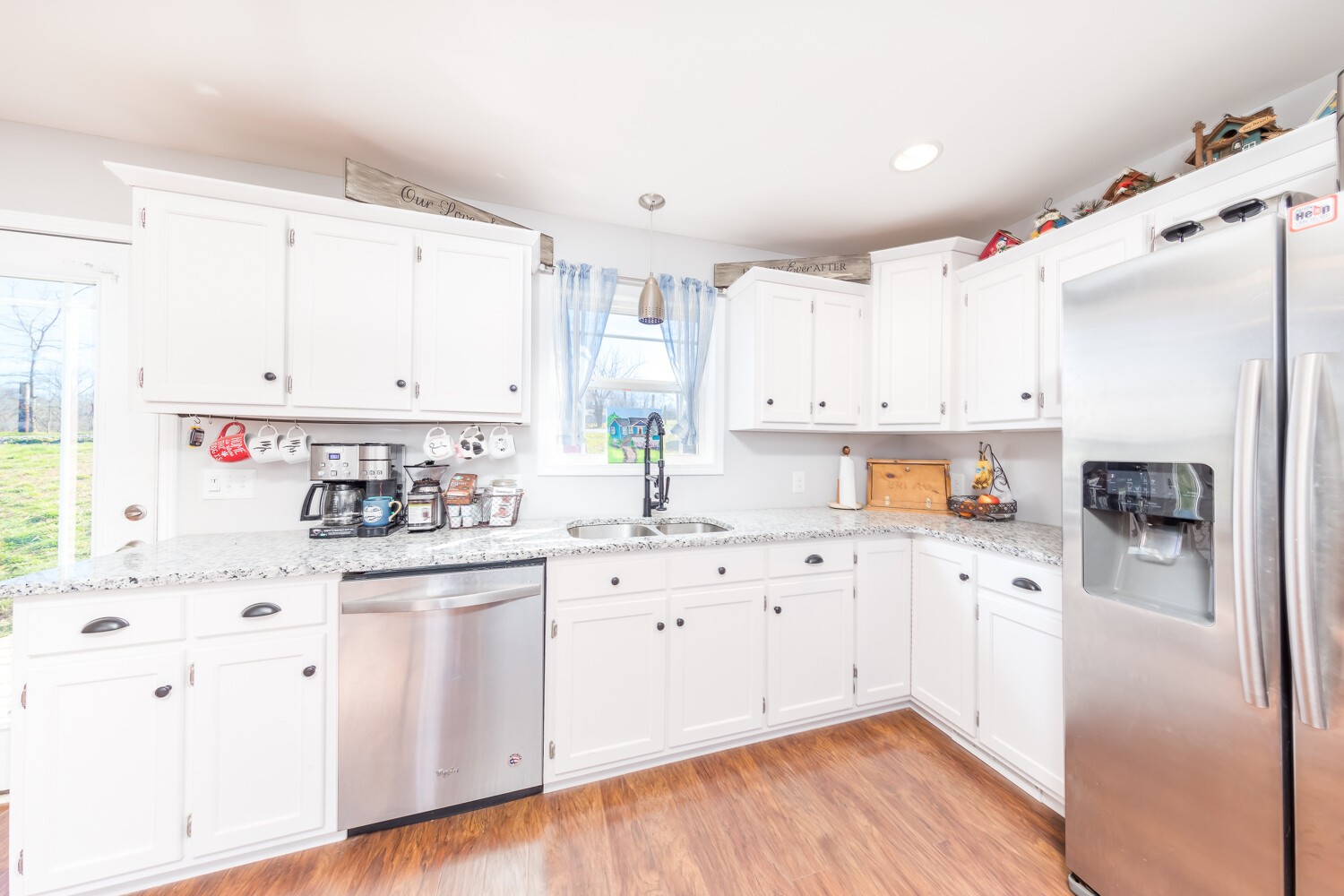 530 Lower Helton Road Alexandria, TN 37012 - Photo 6 of 24 a kitchen with cabinets a sink and white appliances