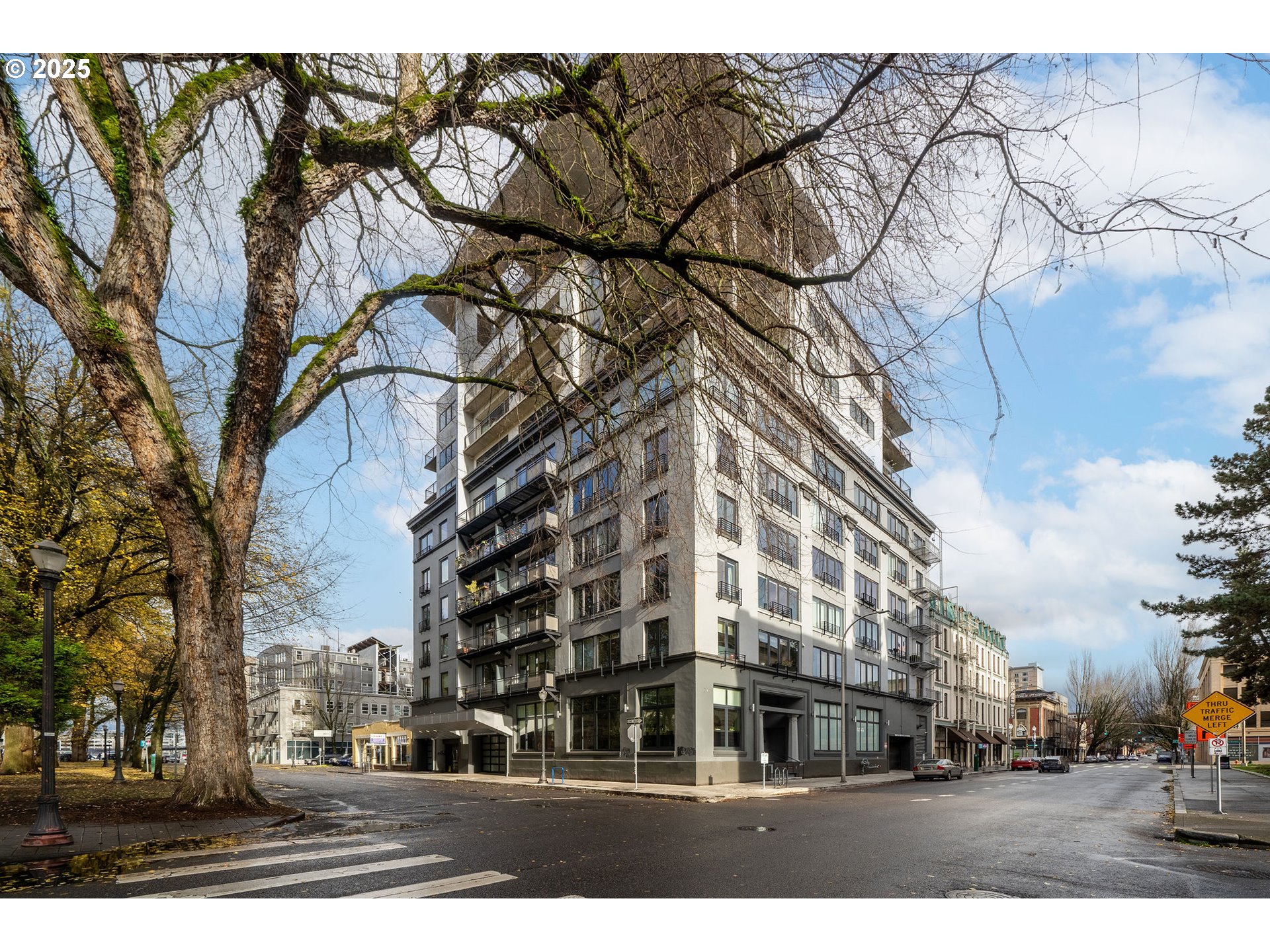 300 Northwest 8th Avenue, Unit 902 Portland, OR 97209 - Photo 2 of 46 a city street lined with buildings and trees