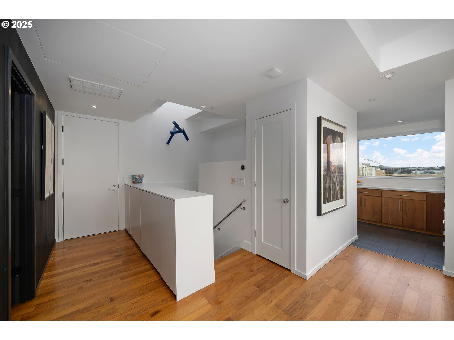 300 Northwest 8th Avenue, Unit 902 Portland, OR 97209 - Photo 5 of 46 a view of a hallway with kitchen and wooden floor