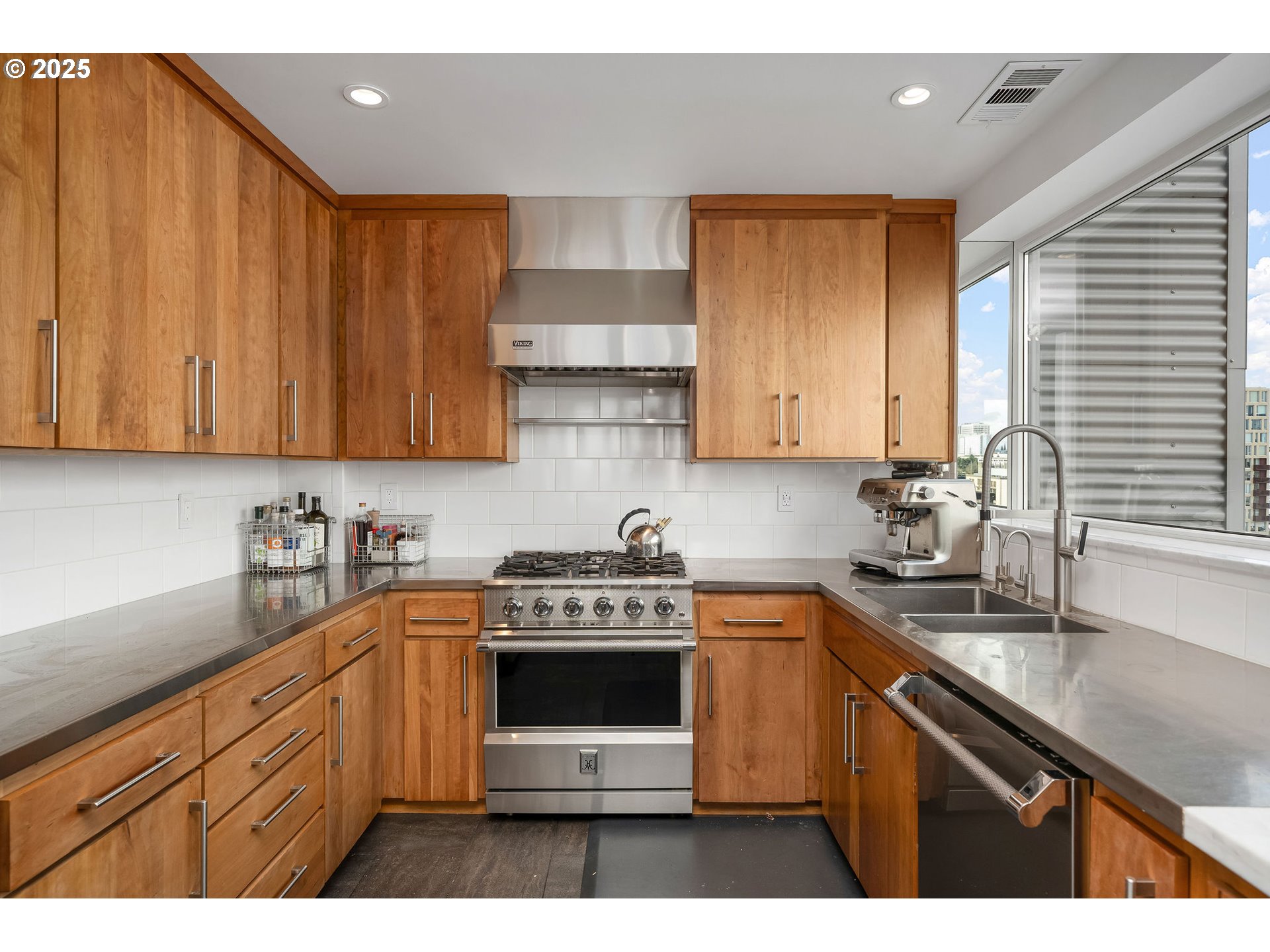 300 Northwest 8th Avenue, Unit 902 Portland, OR 97209 - Photo 6 of 46 a kitchen with stainless steel appliances granite countertop a sink a stove a microwave a refrigerator and cabinets