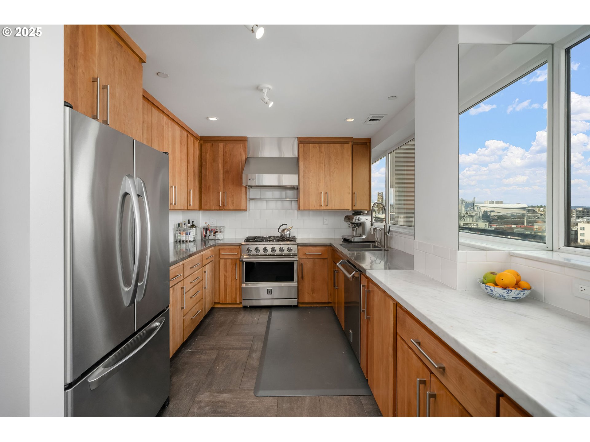 300 Northwest 8th Avenue, Unit 902 Portland, OR 97209 - Photo 7 of 46 a kitchen with stainless steel appliances a refrigerator a sink a stove and a cabinets