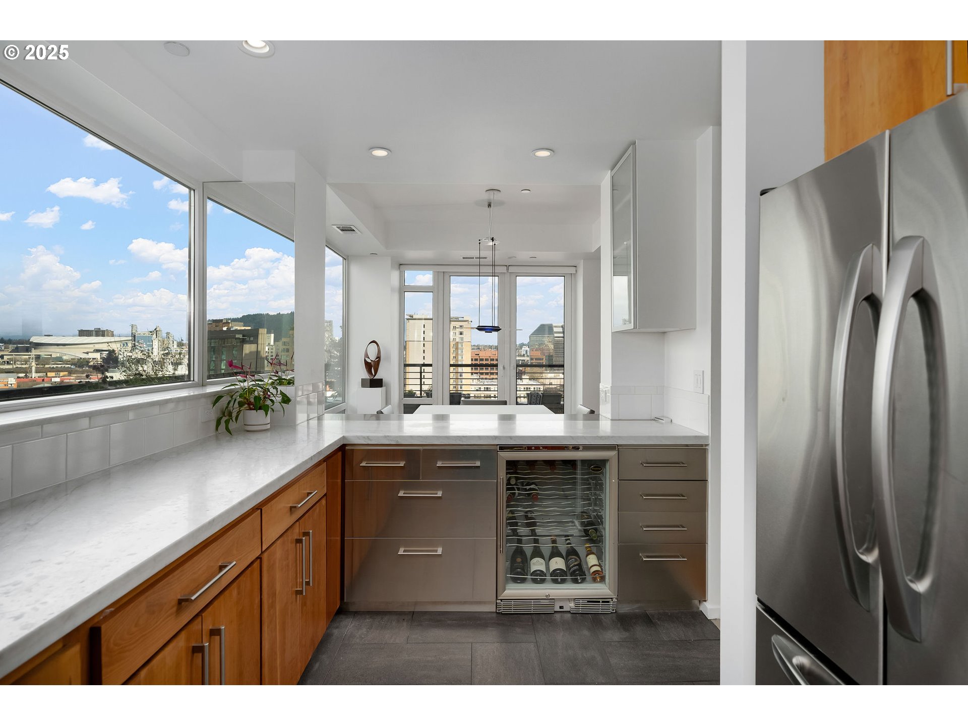 300 Northwest 8th Avenue, Unit 902 Portland, OR 97209 - Photo 8 of 46 a kitchen with stainless steel appliances granite countertop a refrigerator sink and cabinets