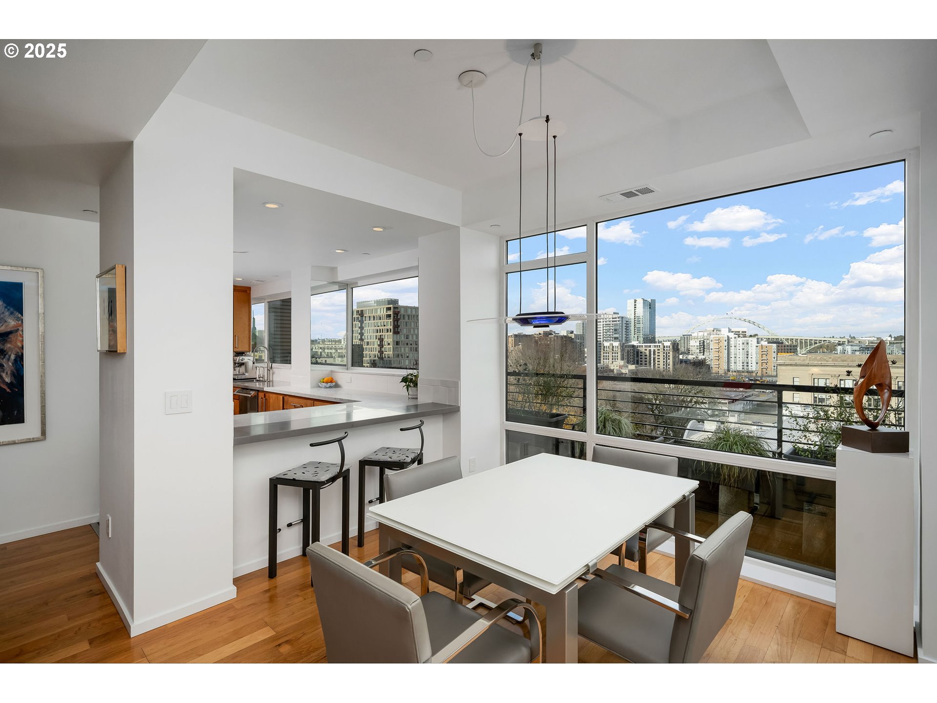 300 Northwest 8th Avenue, Unit 902 Portland, OR 97209 - Photo 9 of 46 a kitchen with a table chairs and a view of kitchen