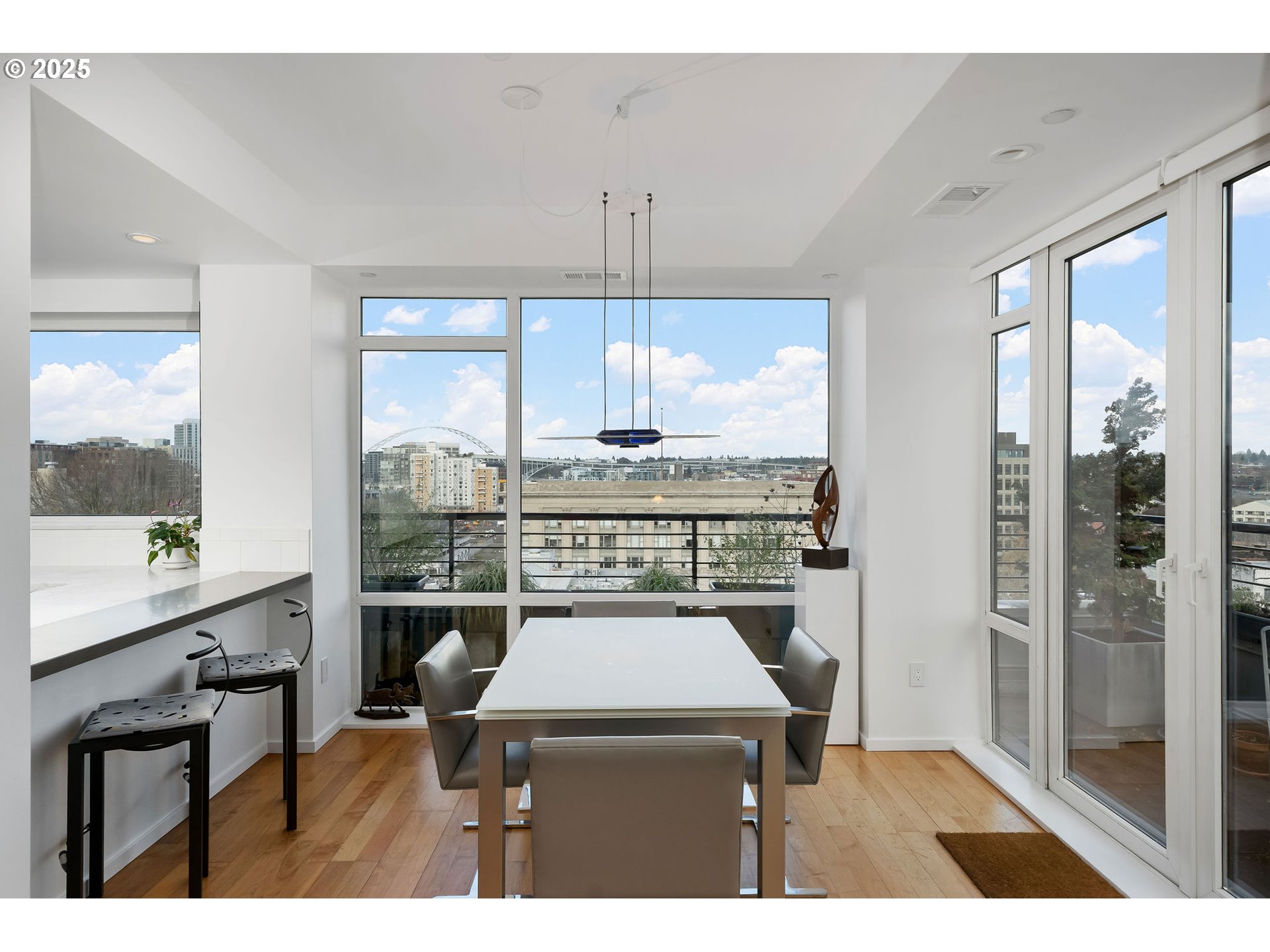 300 Northwest 8th Avenue, Unit 902 Portland, OR 97209 - Photo 10 of 46 a open kitchen with a table chairs and a window