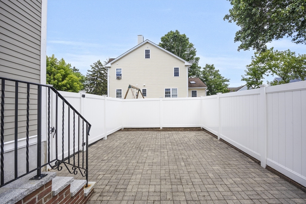 48 Spruce Street, Unit 1 Winchester, MA 01890 - Photo 27 of 29 a view of a house with a yard