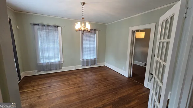 a view of a workspace with furniture and window