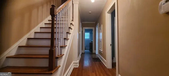 an empty room with wooden floor and door