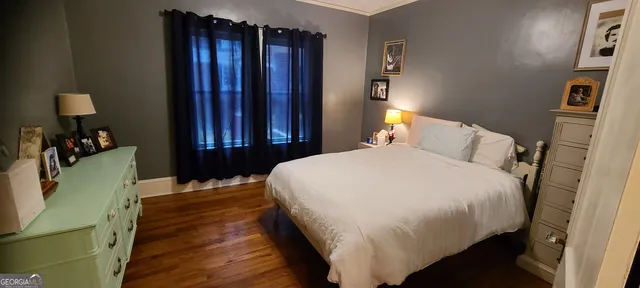 a bedroom with a bed and a mirror on dresser