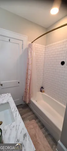 a bathroom with a shower and a bathtub