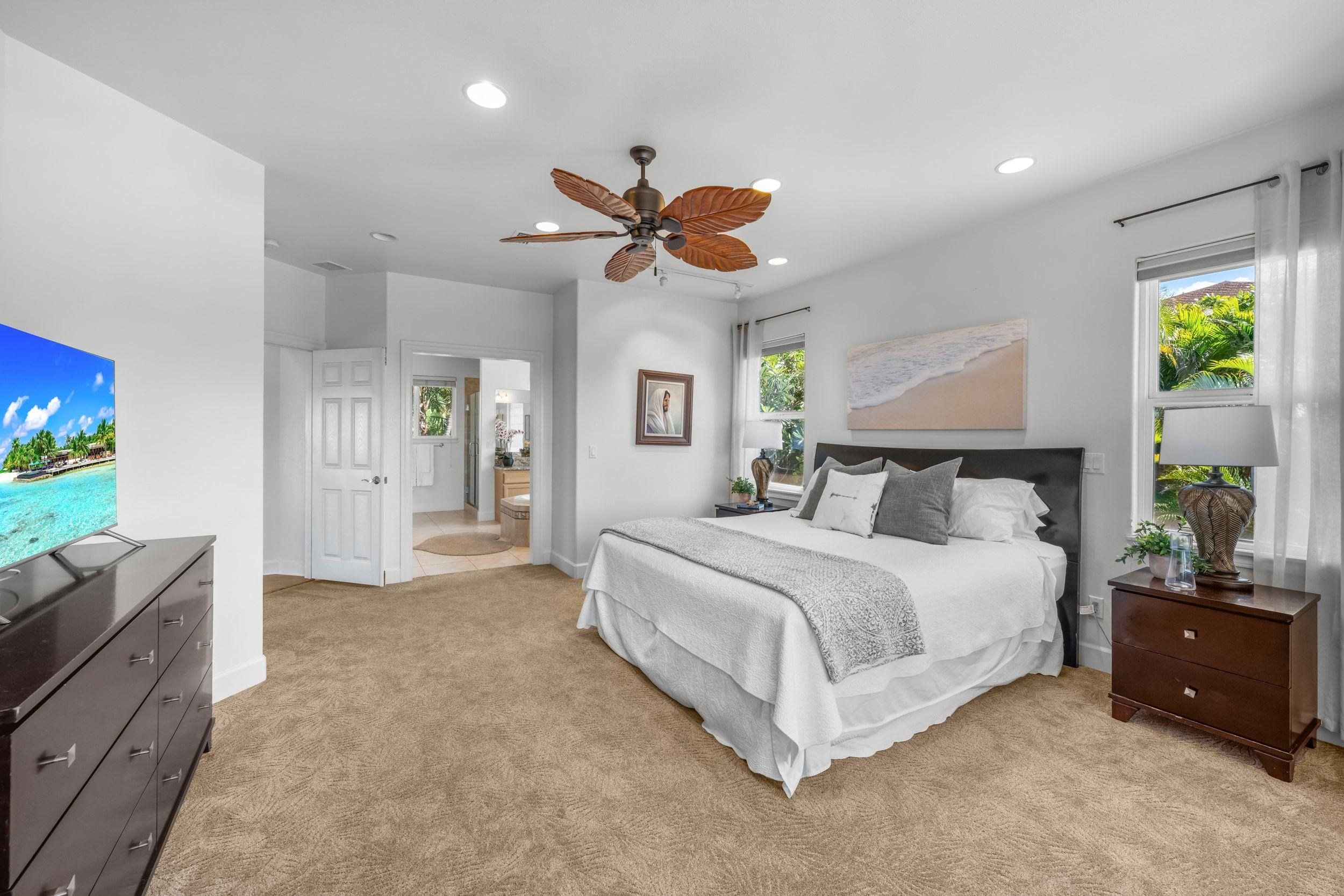 125 Kahana Makai Road Lahaina, HI 96761 - Photo 19 of 46 a spacious bedroom with a bed and a chandelier